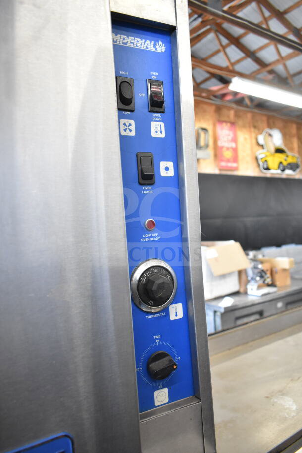 Imperial Commercial Convection Oven control panel showing thermostatic controls, lights, and oven settings in a kitchen.