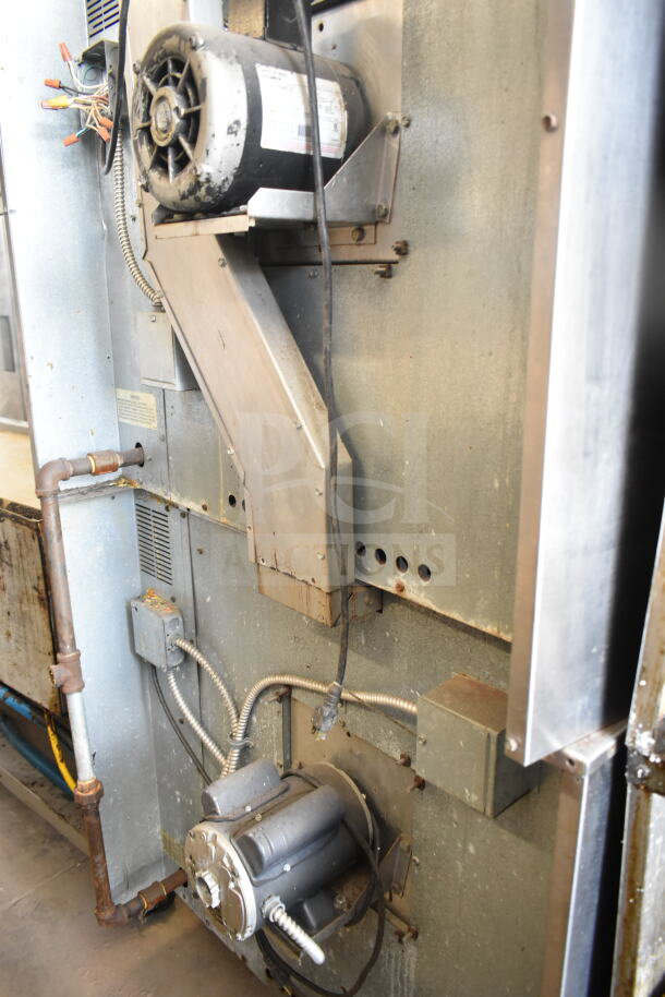 Imperial commercial convection oven side view, showing motor and metal components; used condition, view-through door and controls not visible.
