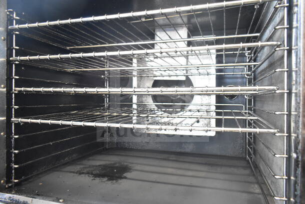 Royal commercial convection oven interior, featuring multiple chrome racks and a visible fan. Natural gas powered.