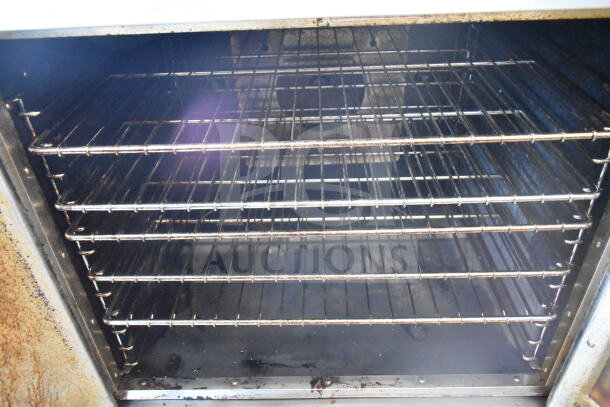 Royal commercial natural gas convection oven with view-through and solid doors, interior racks shown, fair condition.