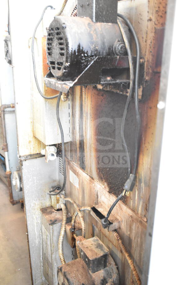 Rear view of Royal commercial convection oven, showing natural gas connections and industrial wear.