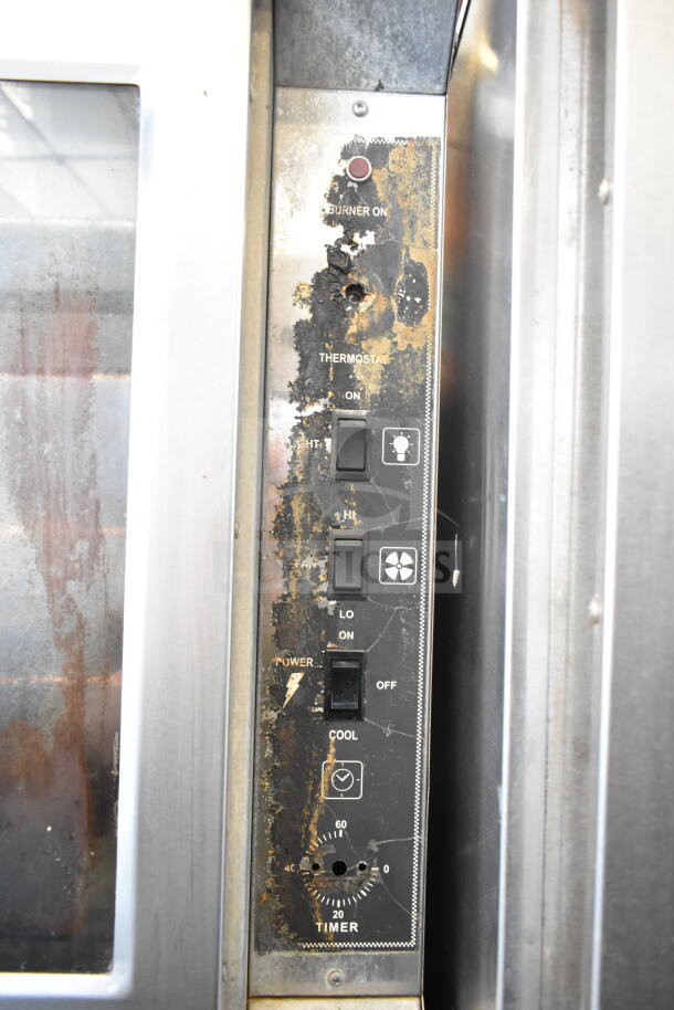 Royal commercial natural gas convection oven controls, worn surface, features on/off switches, timer, fan settings.