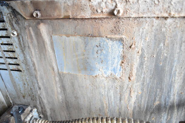 Corroded surface on the exterior of a Royal Commercial Natural Gas Convection Oven, showing signs of wear and tear.