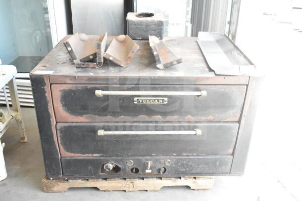 Vulcan commercial natural gas 2-deck pizza oven with metal legs, worn condition, black exterior, visible Vulcan branding.