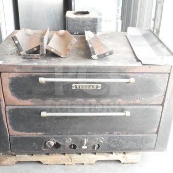 Vulcan commercial natural gas 2-deck pizza oven with metal legs, worn condition, black exterior, visible Vulcan branding.