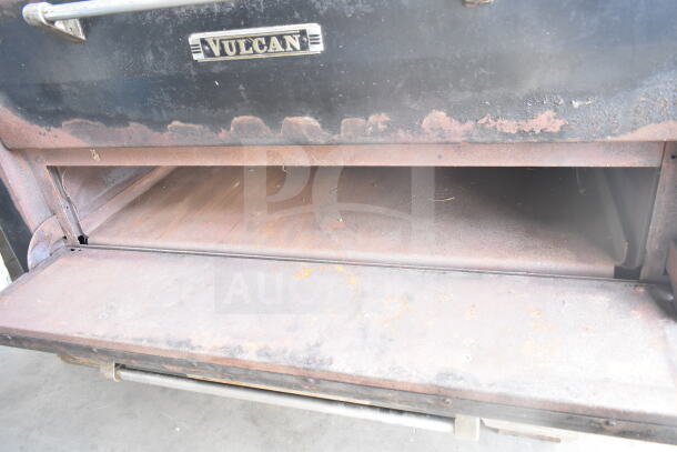 Vulcan commercial two-deck pizza oven with natural gas power, metal legs, and visible wear on the surface.