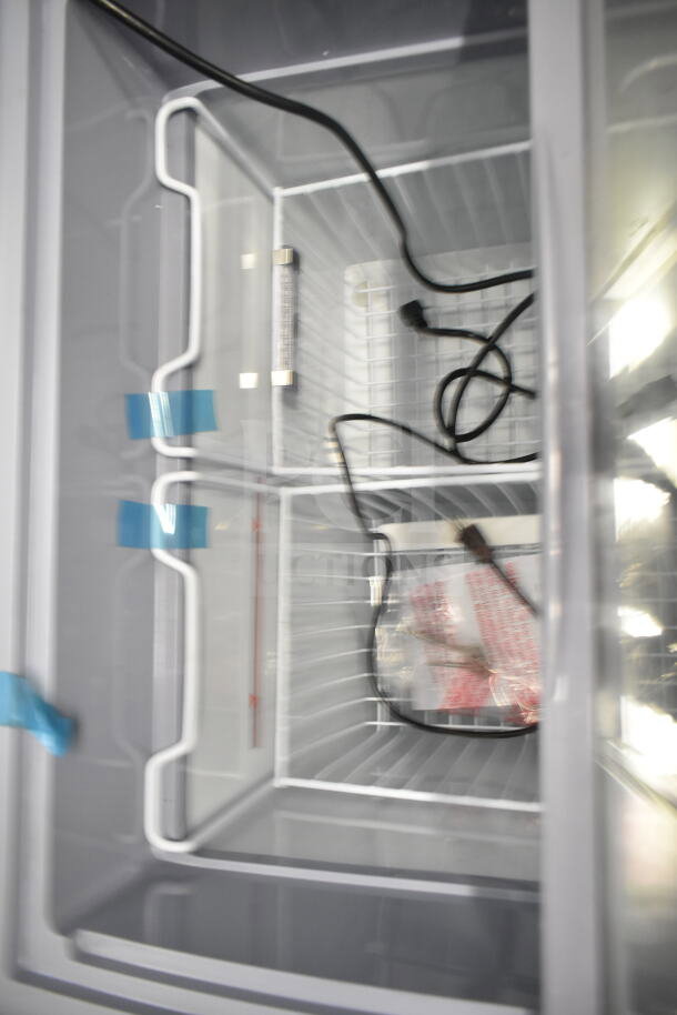 Dogsters XS-160Y chest freezer merchandiser, 115 volts, 1 phase, interior view with wire baskets and cords.
