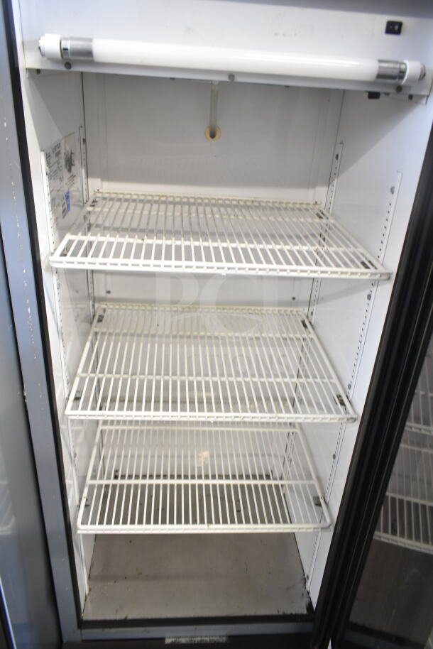 True GDM-12 commercial single door reach-in cooler with adjustable shelves. Model GDM-12, 115 volts, 1 phase. Clean interior.