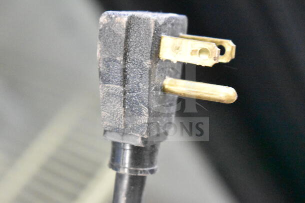 Close-up of a power plug for True GDM-12 commercial cooler, 115 volts, showing prongs and cord in used condition.