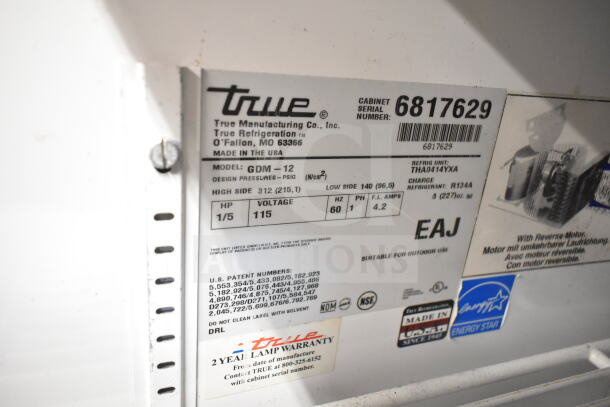 True GDM-12 cooler merchandiser label, 115V, 1 Phase, showcases model, serial number 6817629, and warranty information.