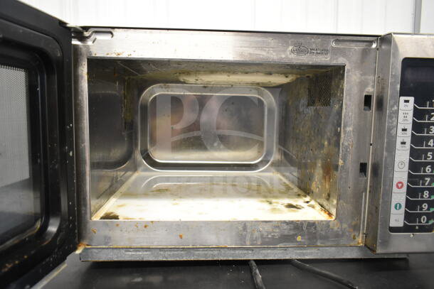2022 Amana RCS10TS commercial microwave, 120V, visible interior wear, stainless steel, keypad controls.