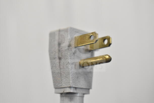 Close-up of a three-prong electrical plug for the 2019 True GDM-41SL-48-HC-LD cooler. The plug is in good condition.