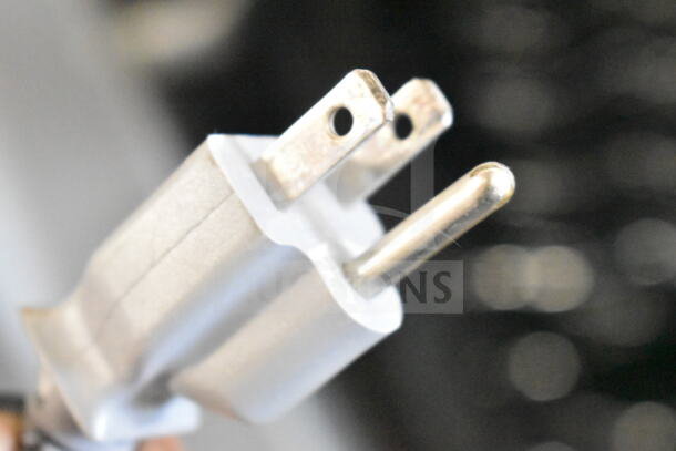 Close-up of a power plug for the General Electric PWR04FANBBS mini beverage cooler, highlighting compatibility with 115 volts.