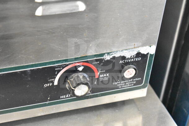 Winco FW-S600 countertop food warmer control panel. Features adjustable heat settings, visible wear, 120 volts, 1 phase.