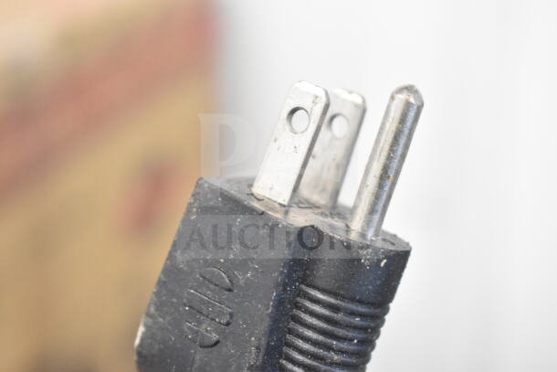Close-up of the plug from a Winco FW-S600 Countertop Food Warmer, 120 volts, 1 phase. Shows plug condition.