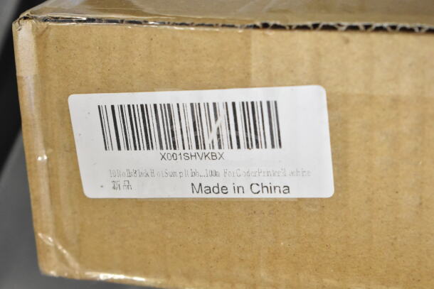 Brown cardboard box with a label showing barcode X001SHVKBX. Marked "Made in China." Contains 10 rolls of black hot stamping ribbon, 100m, for coder/printer.