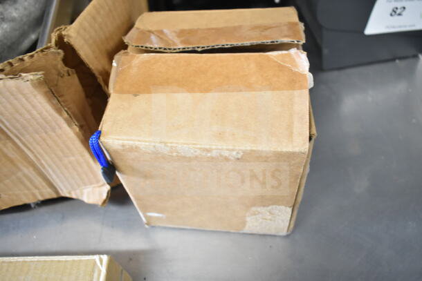 Two cardboard boxes, partially opened, showing signs of wear and tape residue; auction includes two items inside.