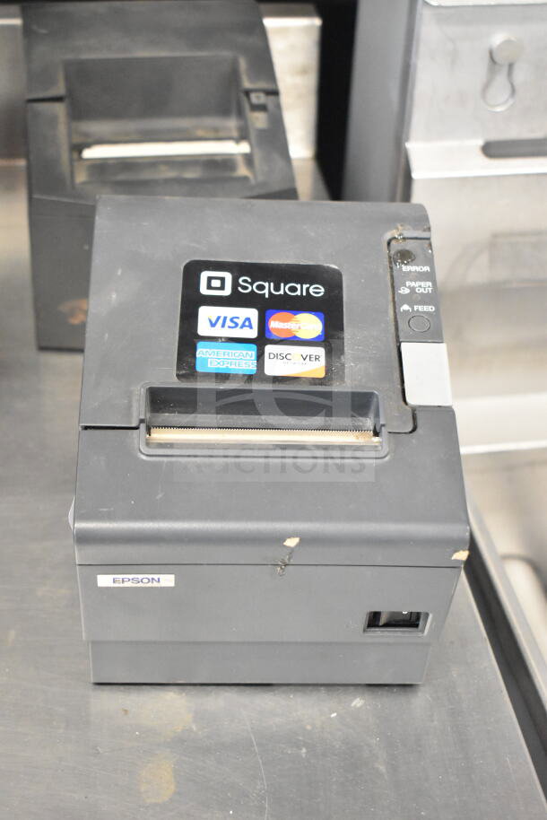 Epson M129H receipt printer with Square compatibility, showing wear. Labels for Visa, MasterCard, and other cards.