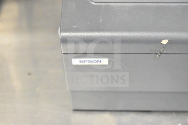 Epson M129H receipt printer, showing an Epson logo. Black casing with minor wear marks.