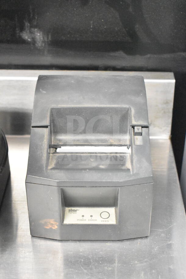Epson M129H / Star TSP600 receipt printer, black, used condition, features power, error, and feed buttons on front panel.