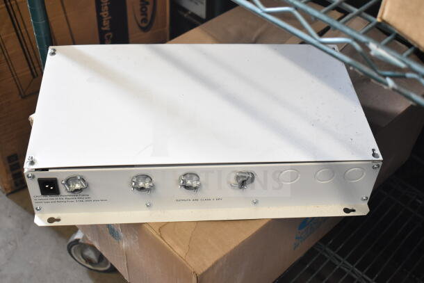 Sensormatic ZE9060 Controller with output fusing warning, light wear, on warehouse shelf.