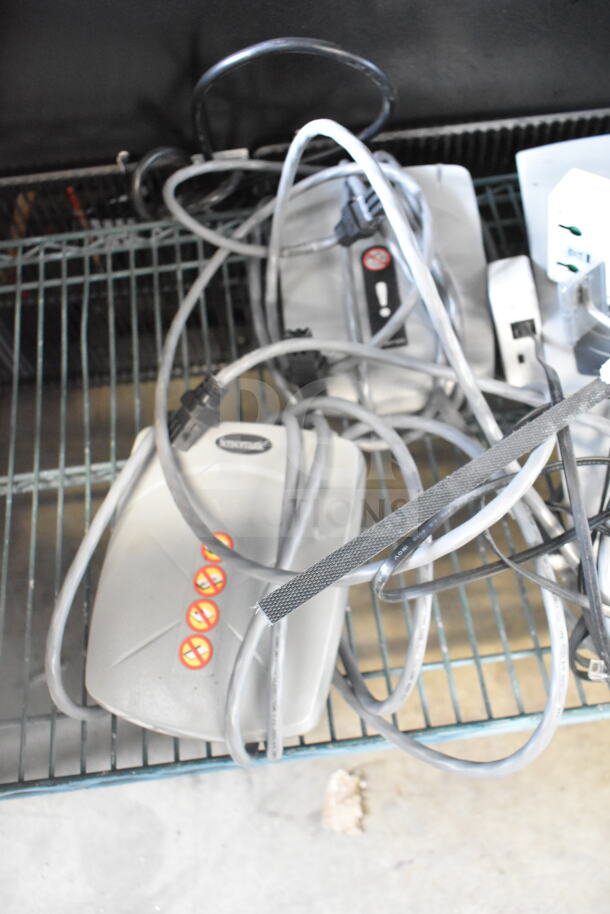 Sensormatic ZE9060 controller, ZBSMPSPE antenna deactivators, ZBSMPCPE Pad Pro with cables; 6 items on shelf.