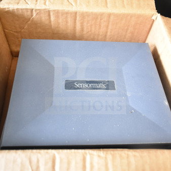 Box containing Sensormatic items, featuring ZBAMB9010-IPS Label Deactivator, pristine condition.