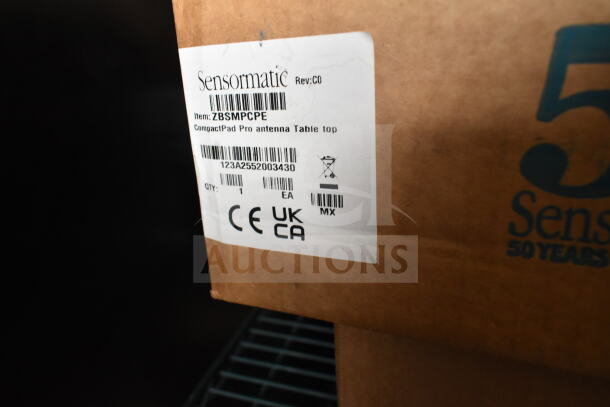 6 Sensormatic items including ZBAMB9010-IPS label deactivator. Box labeled ZBSMPCPE CompactPad Pro Antenna.