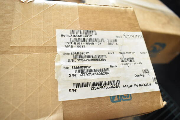Cardboard box with Sensormatic labels, marked ZBAMB9012. Serial number 123A2545508284. Made in Mexico.