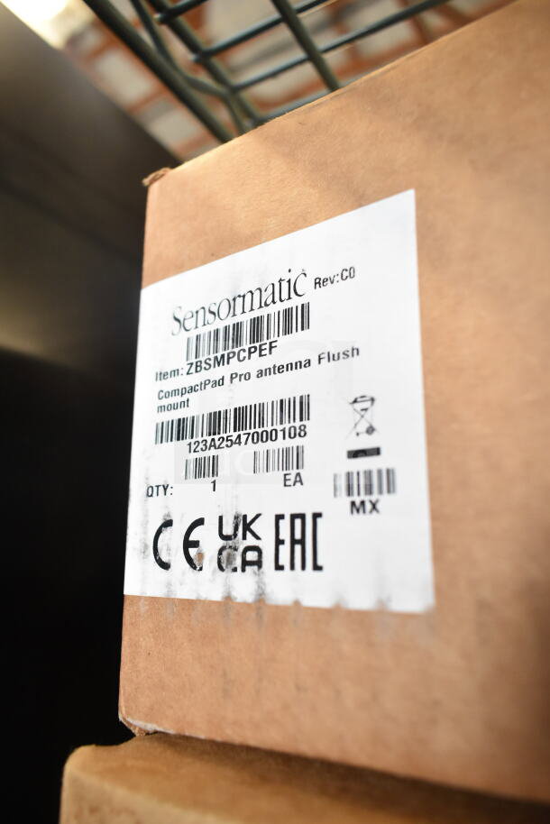 Sensormatic label showing ZBSMPCPEF CompactPad Pro Antenna Flush Mount packaged, with CE, UKCA, EAC markings.
