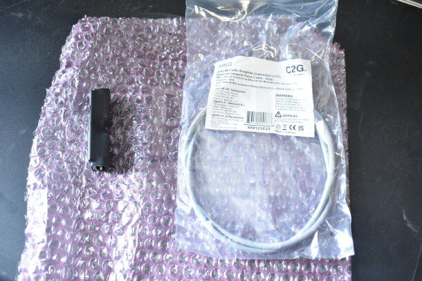 4 Sensormatic 0352-0659-01 Ethernet Isolators on bubble wrap; new condition with packaging.