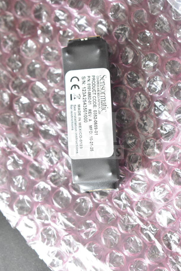 Sensormatic 0352-0659-01 Ethernet Isolator on bubble wrap, with label showing product code and manufacturing details.