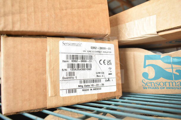 4 Sensormatic 0352-0659-01 Ethernet Isolators in original boxes, marked with serial number and manufacturing details.