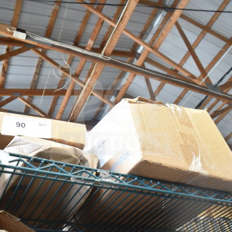Boxes containing Sensormatic Remote Alarm Module Kit, Deactivator Antenna, ZBSMP-B2 Mount on metal shelf.