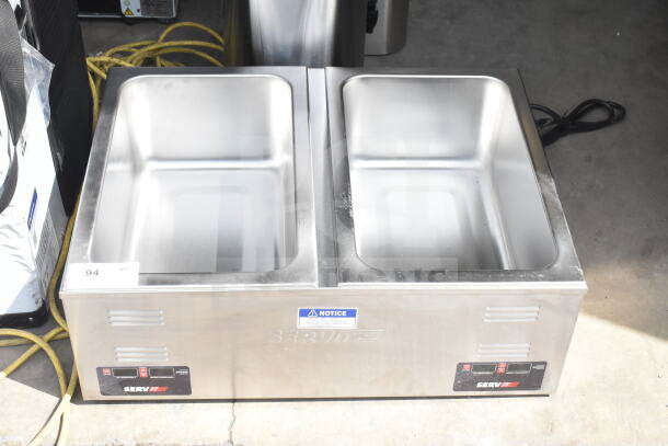 Brand new ServIt 423FW200D dual well electric countertop food warmer, 12" x 20", digital controls, 120V, slight scratches visible.