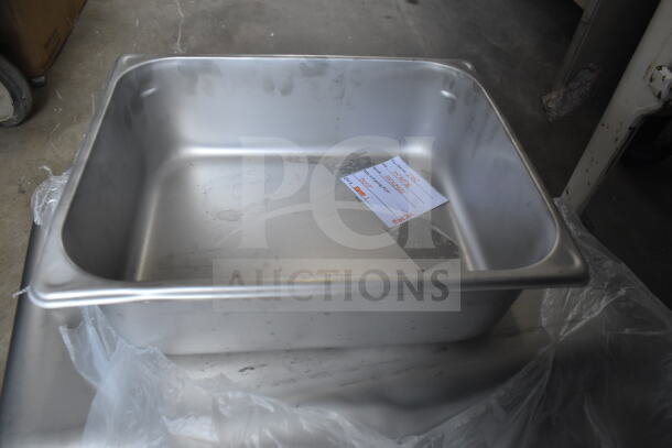 5 Brand New Vigor stainless steel steam table pans, varying sizes, anti-jam feature, visible light scratches, auction tag inside.
