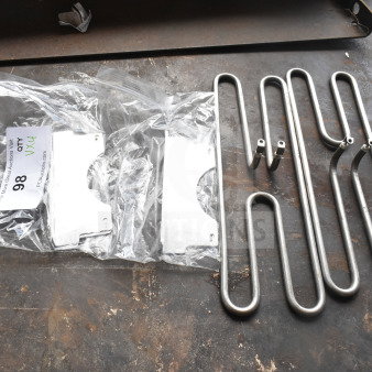 Four brand new scratch and dent items, including two metal burners and metal pieces, labeled "qty 4x4," auction lot 98.