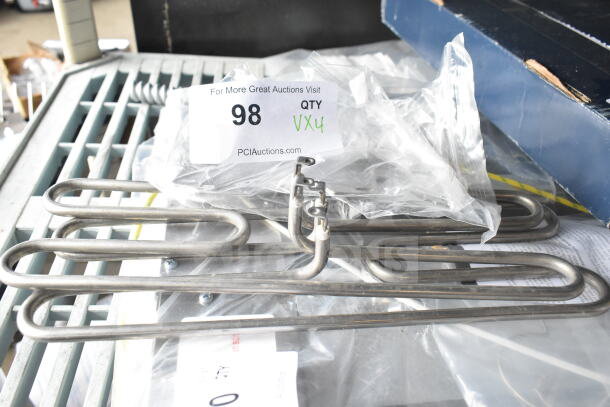 Four brand new scratch and dent items including two metal burners and components, with auction tag indicating 4x bid value.