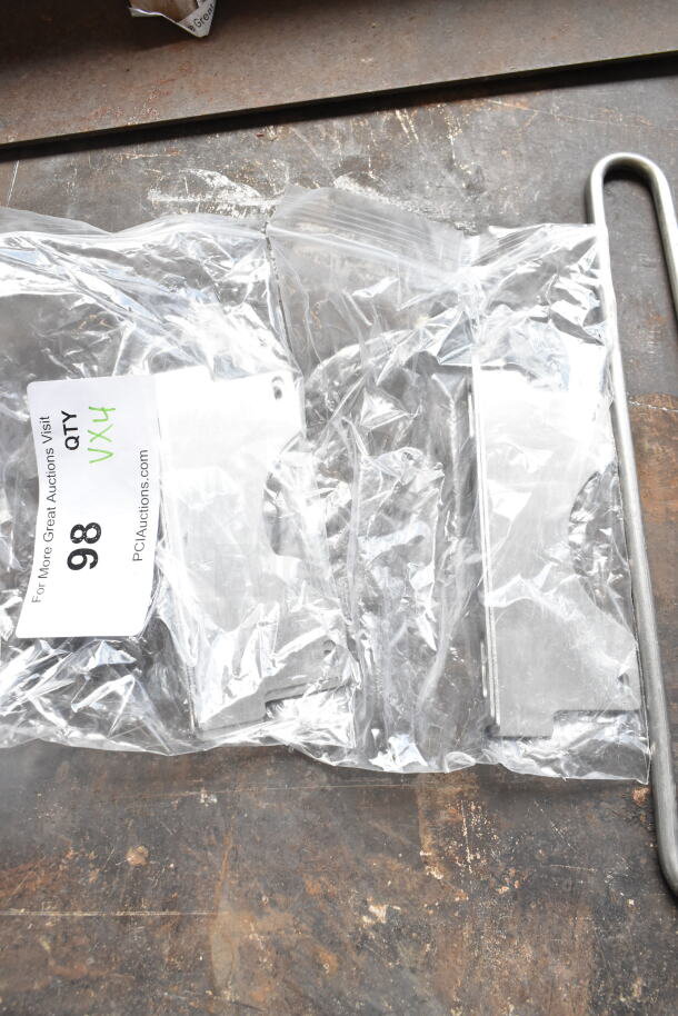 4 brand new scratch and dent items including 2 burners and metal pieces in sealed plastic bag with auction tag marked "VX4 QTY 98".