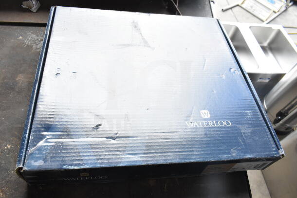 Box of a BRAND NEW SCRATCH AND DENT Waterloo Faucet, model 750FD4126, with visible damage and original packaging.