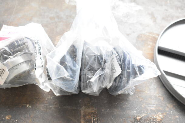 5 brand new scratch and dent items in plastic bags, including Robot Coupe blade and oven knob. Tags visible.