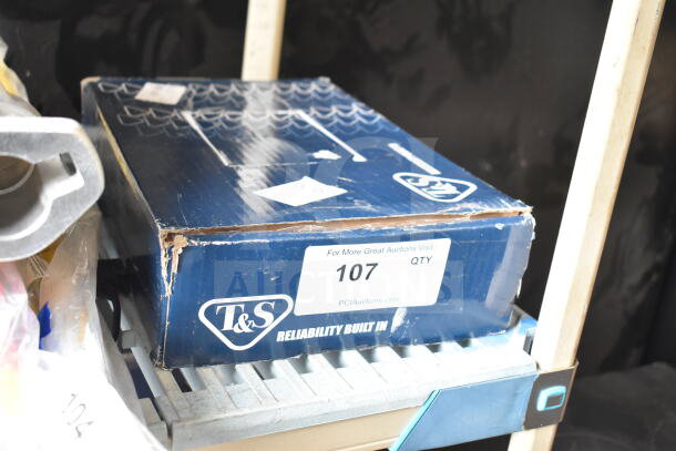 Box of T&S EC-3101 CheckPoint Sensor Faucet, slight box damage. Label shows auction details and item number 107.