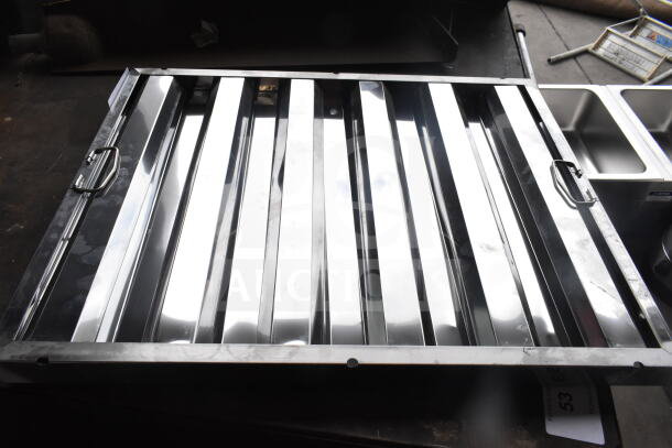 Stainless steel hood filter, 16"H x 16"W x 2"T, brand new with visible scratches and dings, features handles for easy use.