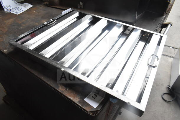 Brand new 16"x16"x2" stainless steel hood filter, reflective and durable, slight scratch on surface, handle visible.