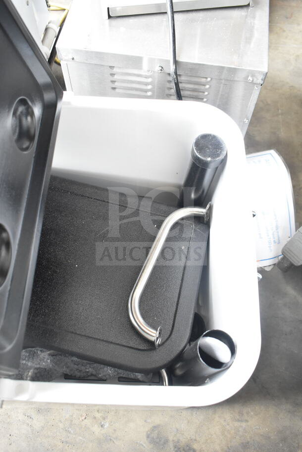 Brand new cooler with minor scratches; features sturdy black handles and ample interior space.