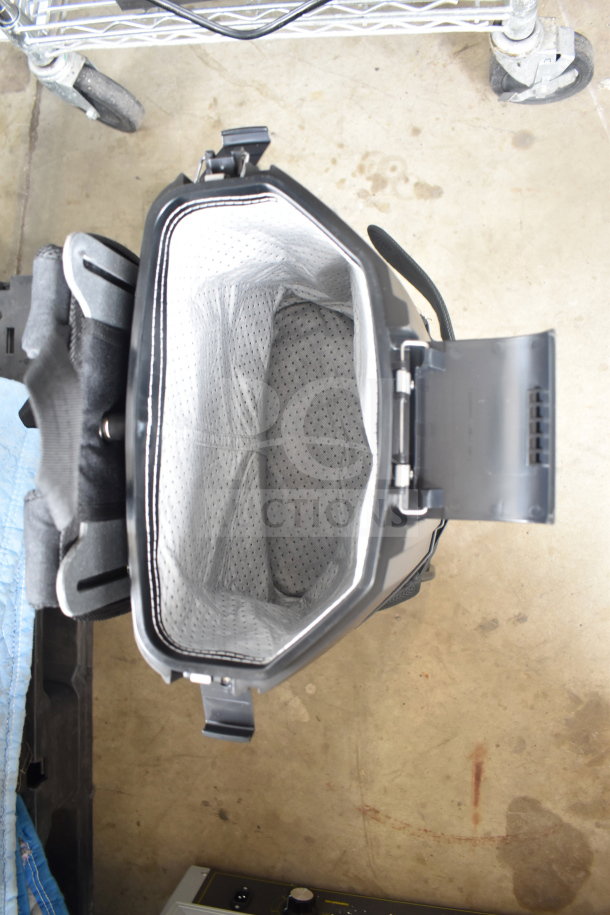 Hoover CH93600 cordless backpack vacuum, new with scratches, open view. Includes 10 bags, 8.0 Ah battery, and charger.
