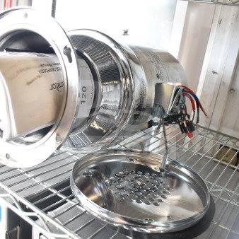 Brand new InSinkErator SS-100-47 commercial garbage disposer, 208/230/460V, 3-phase, stainless steel, minor scratches visible.