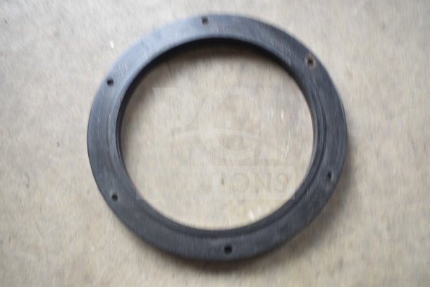 A black circular gasket with bolt holes, likely part of the InSinkErator SS-100 garbage disposer.