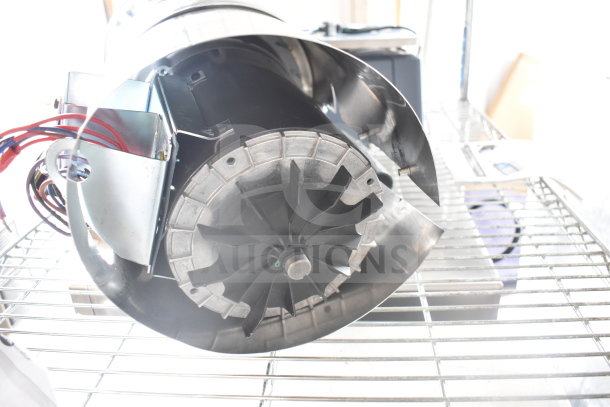 Brand new InSinkErator SS-100-47 garbage disposer, 208/230/460V, 3 phase, scratch and dent, visible wiring and metal casing.