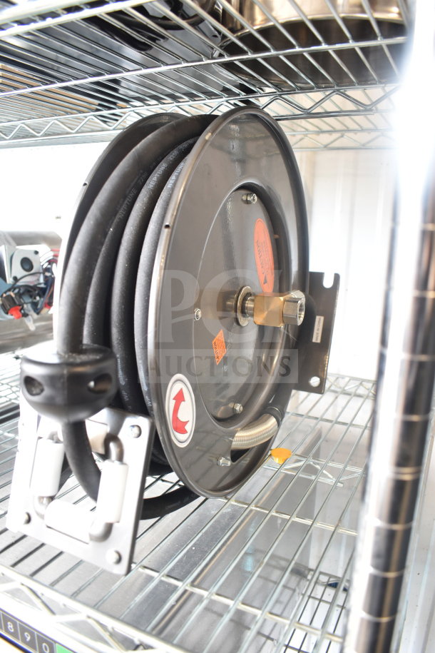 BRAND NEW Equip 5HR-232-01 hose reel with 35' hose, 2.27 GPM spray valve. Minor scratches, mounted on a metal shelf.